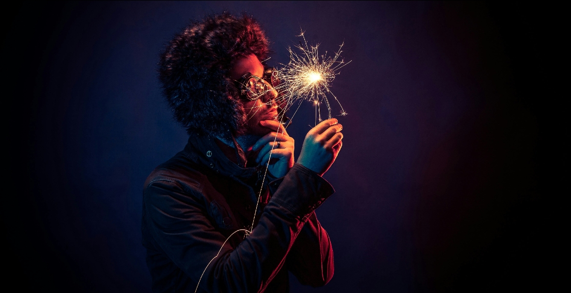 Photograph of a man looking at a spark