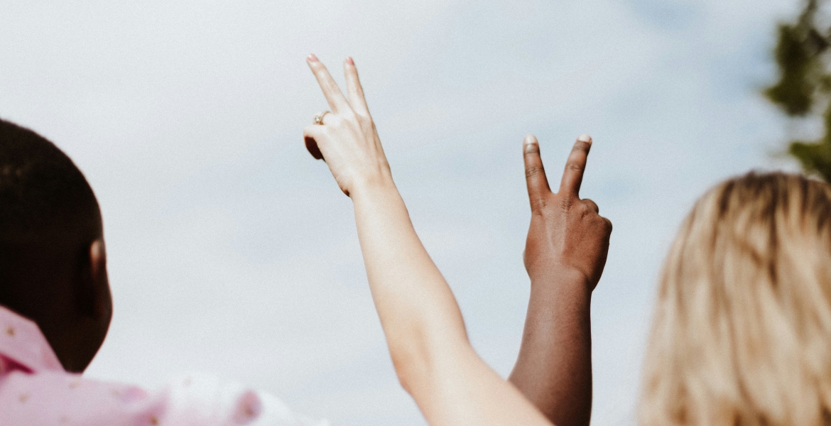 Photograph of a Black man and a blonde woman from behind