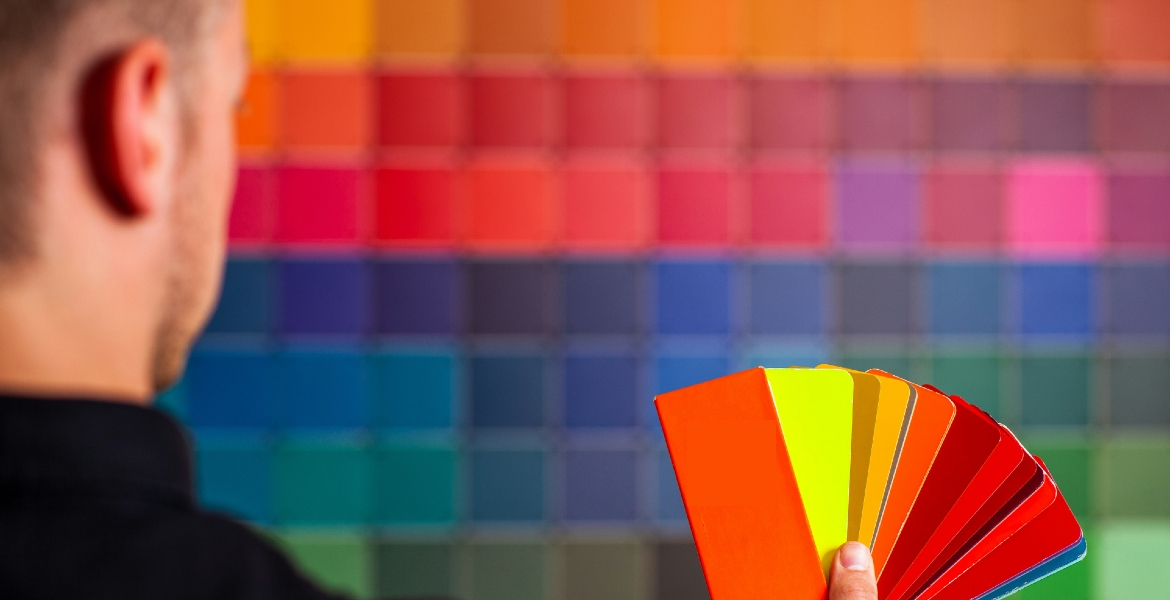 Photograph of a man holding a color chart