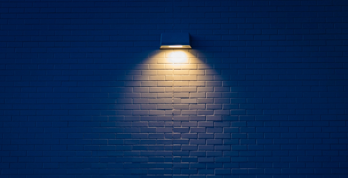Photograph of a wall lamp on a blue wall