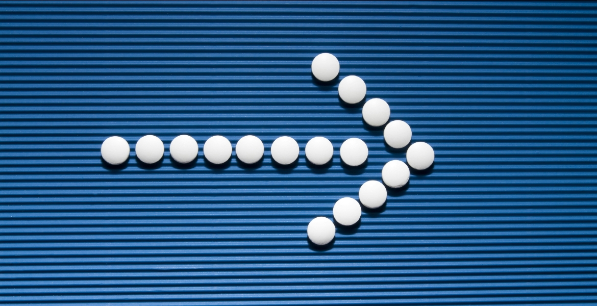 Photograph of white arrows on a blue wall