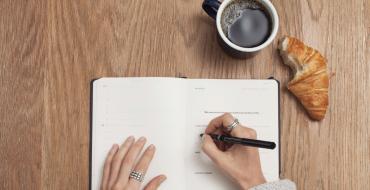 Photograph of a woman's hand writing in a diary
