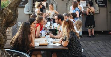 Photograph of people having lunch on a terrace in Paris.