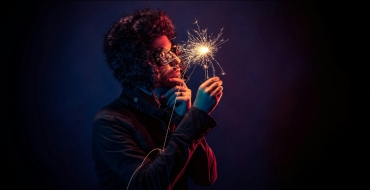 Photograph of a man looking at a spark