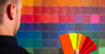 Photograph of a man holding a color chart