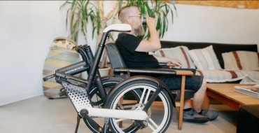 Photograph of a man with a physical disability drinking