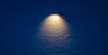 Photograph of a wall lamp on a blue wall